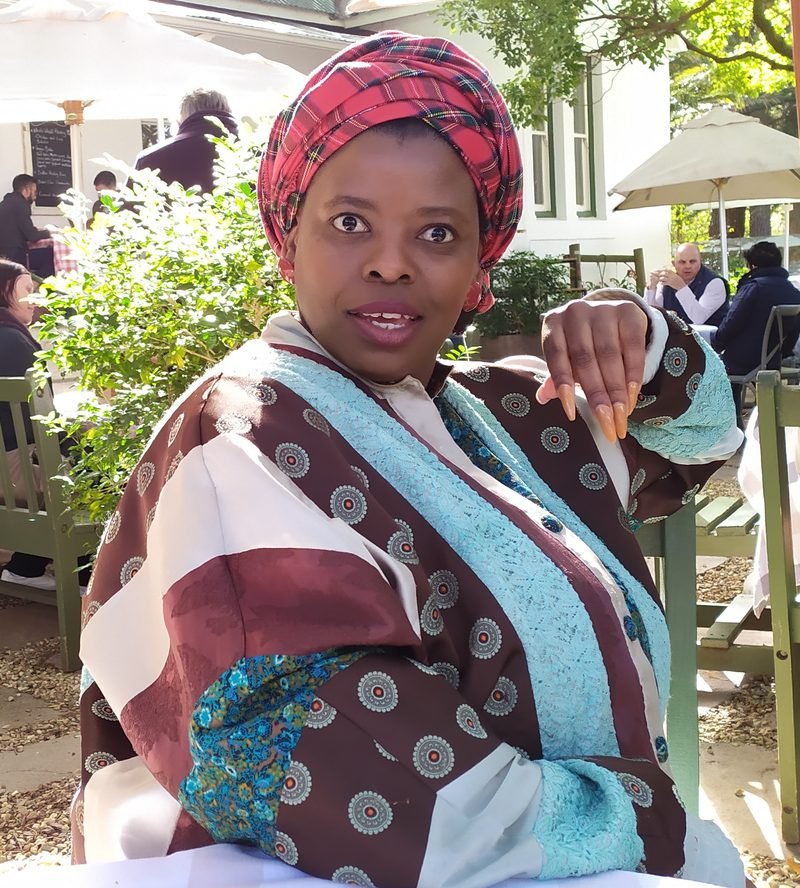 Jabu — a warm empathetic listener and friend who listens, wearing traditional attire